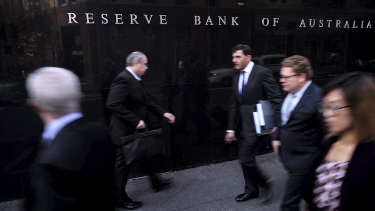 Business professionals walk past the Reserve Bank of Australia, highlighting mortgage rate changes that affect borrowers.